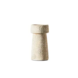 Høj lysestage med rustikt, tekstureret overflade, der er cylindrisk og smalner mod bunden.