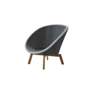 Loungestol med buet ryglæn i flettet mønster og skrå ben, moderne design.