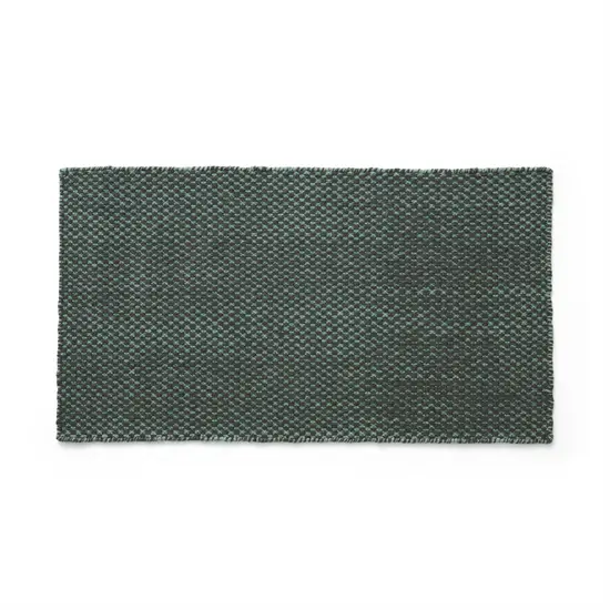 Rektangulær dørmåtte i mørk smaragdgrøn med tekstureret overflade, måler 52x95 cm.