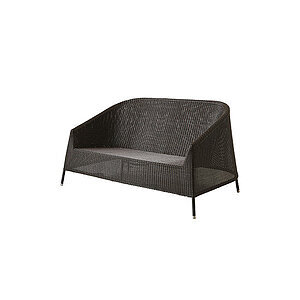 To-personers sofa i moderne, rundet design med tekstur og slanke, skrå ben.
