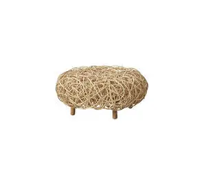 Rund fodskammel i naturligt rattan med vævet mønster. Fire korte ben løfter den lidt fra gulvet.