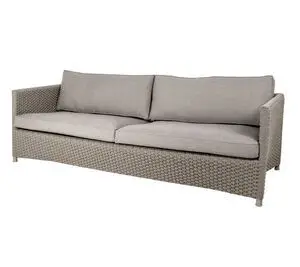 Sofa til tre personer med taupefarvet polstring, tykke puder og vævet tekstur på ramme og armlæn.