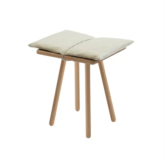 Fritz Hansen Georg skammel med tre ben og beige hynde, minimalistisk design.