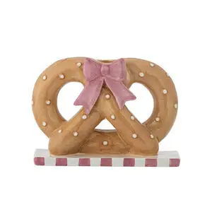 Lysestage formet som kringle med små prikker, lyserød sløjfe og lyserøde/hvide striber på basen.