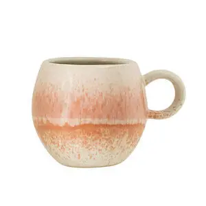 Rundt keramisk krus med rosa til orange farvegradient og spraglet tekstur.