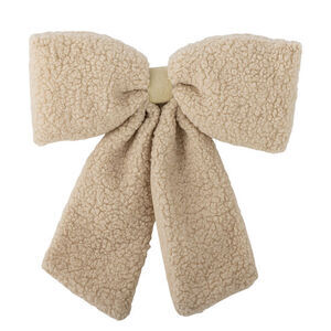 Dekorationssløjfe i beige med fluffy tekstur og metalklemme på bagsiden.