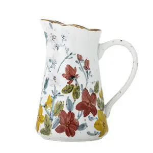 Kande med røde, gule, blå blomster, bølget gylden kant og buet hank.