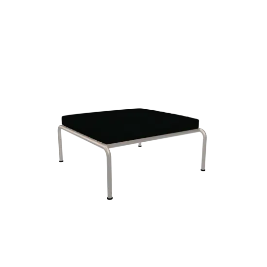 Minimalist ottoman med mørk pude og hvidt stel, fra Houe AVON, enkel og stilren.
