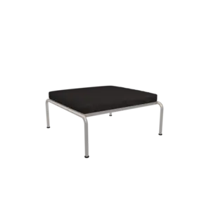 Ottoman med mørk skiferpude og hvidt metalstel, minimalistisk design.