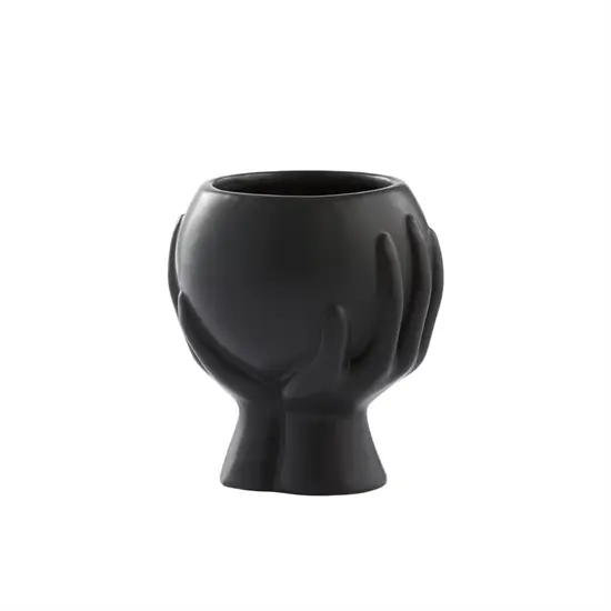 Sort keramisk skjuler med glat finish og skulpturelt design, rund åbning til planter.