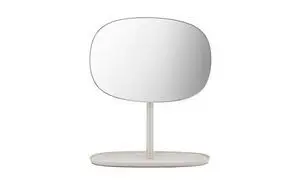 Ovalt spejl på stander med flad, oval base i beige. Enkel og moderne design.