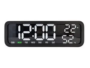 Digital vækkeur med sort træfinér, viser 12:00, mandag, 22°C og 52% luftfugtighed.