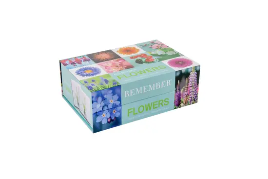 Rektangulær æske med farverige blomsterbilleder og teksten "Remember - Flowers" på siden.