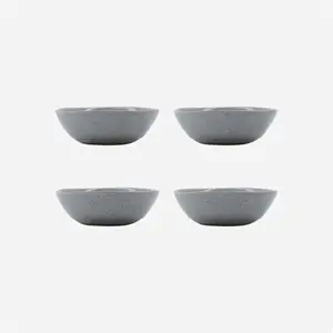 Fire lyseblå skåle med prikket mønster, arrangeret i to rækker.